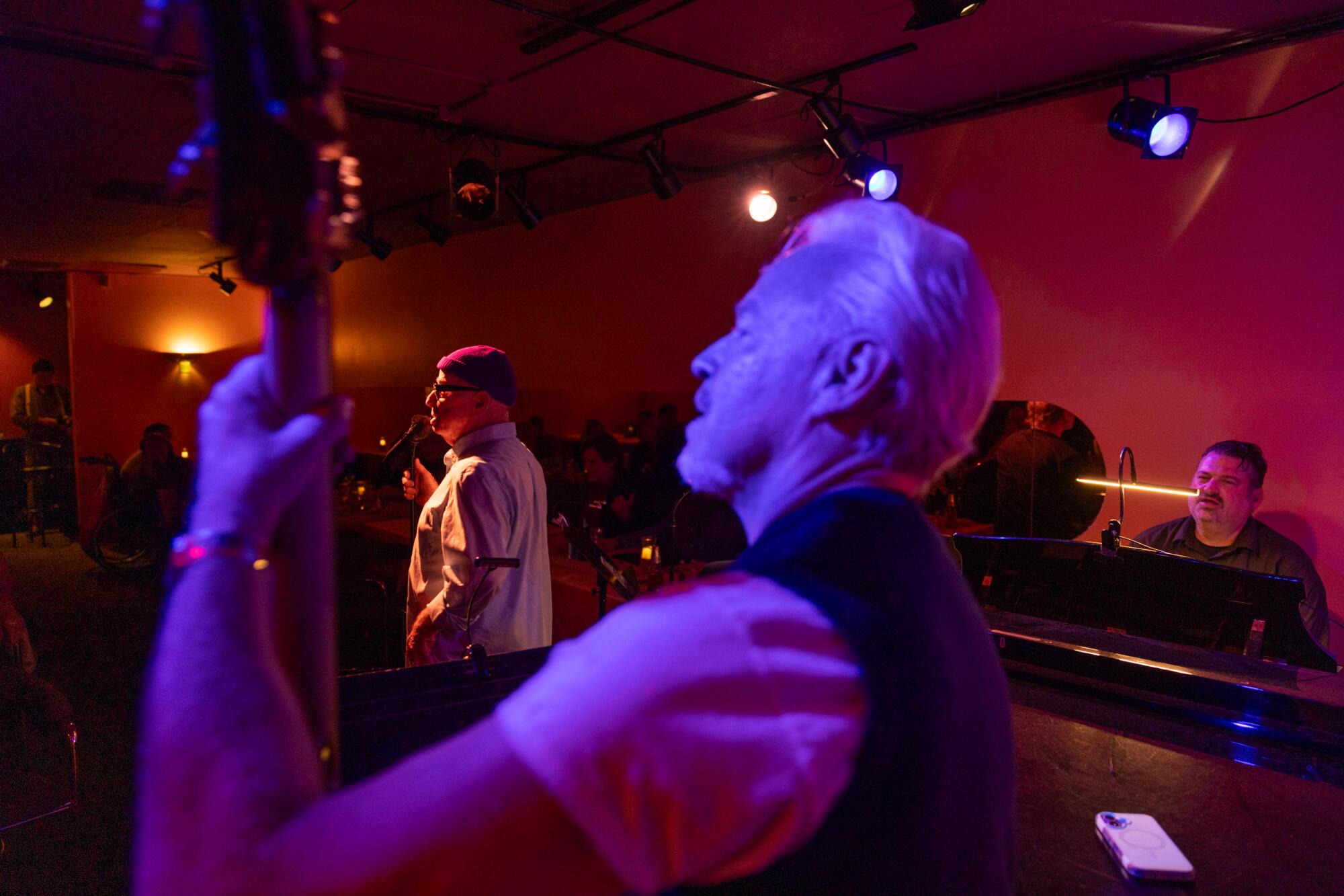 Tom Noble, left, sings alongside bassist Adam Cohen, center, and pianist Andy Langham