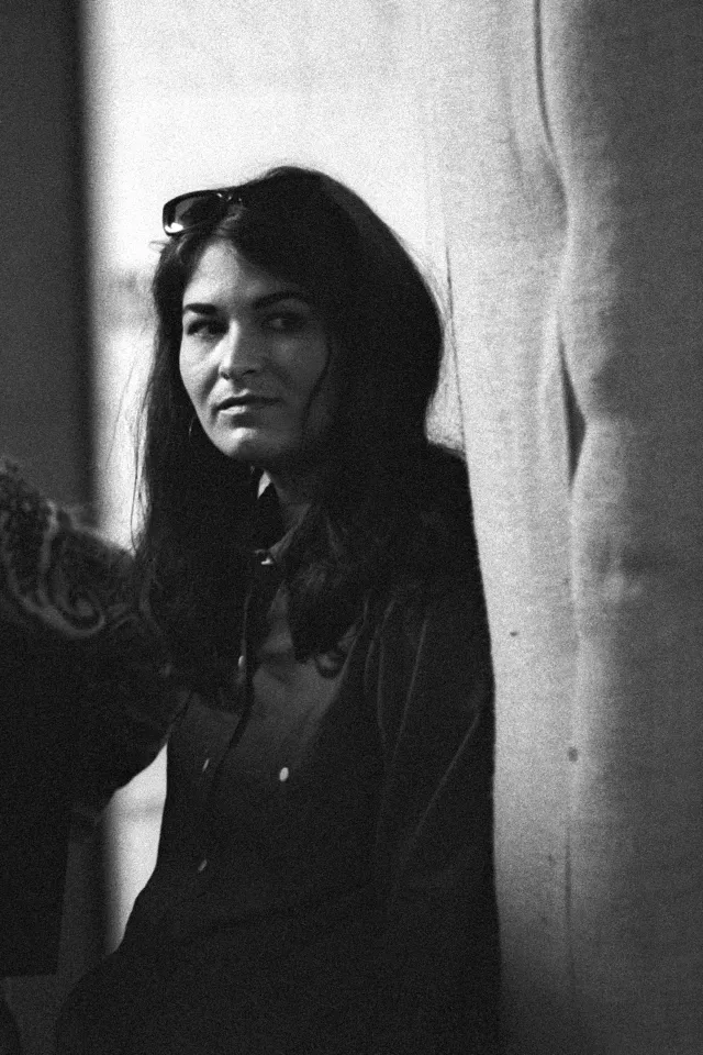 Black and white photo of Cher in a recording session.