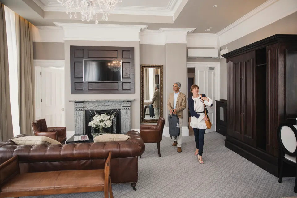 Husband surprising his wife with a luxury hotel room.