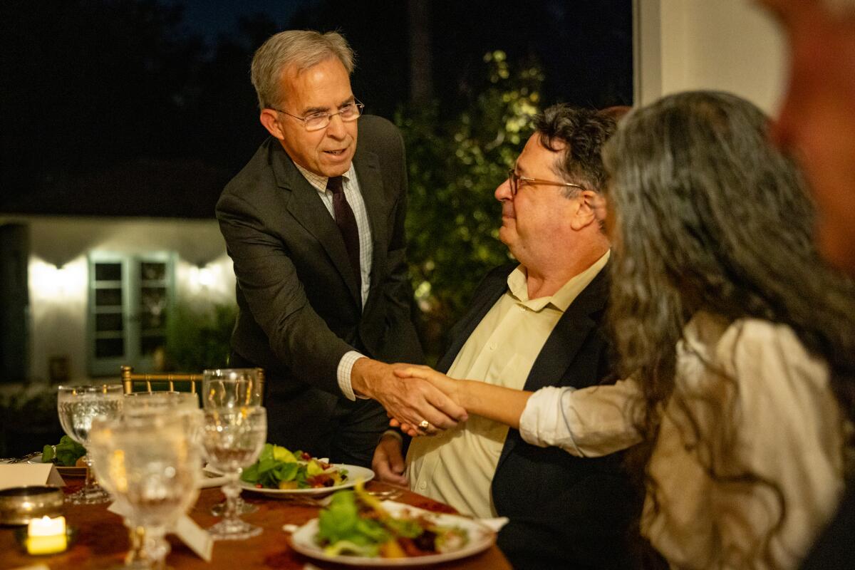 Rick Atkinson greets guests at his table.