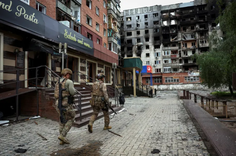 FILE PHOTO: Members of the White Angel unit of Ukrainian police officers who evacuate people from the frontline towns and villages, check an area for residents, amid Russia's attack on Ukraine, in the frontline town of Pokrovsk in Donetsk region, Ukraine May 21, 2025. REUTERS/Anatolii Stepanov/File Photo