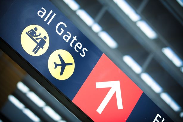 Directional sign at Seattle Tacoma International Airport pointing travelers to the ticketing and gates.