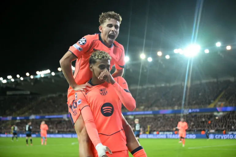 Barcelona's Spanish forward #10 Lamine Yamal (bottom) celebrates with Barcelona's Spanish midfielder #16 Fermin Lopez (top) after scoring the equalizing 2-2 goal during the UEFA Champions League league phase day 4 football match between Club Brugge and FC Barcelona at Jan Breydelstadion stadium, in Bruges, on November 5, 2025. (Photo by NICOLAS TUCAT / AFP)